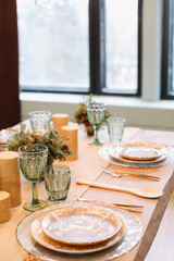 Festive table setting for Christmas dinner at home. New year and Christmas decorations. Winter holiday theme. Happy New Year 2020