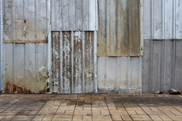 Old metal sheet roof texture. Rusty metal sheet texture with Concrete block flooring .