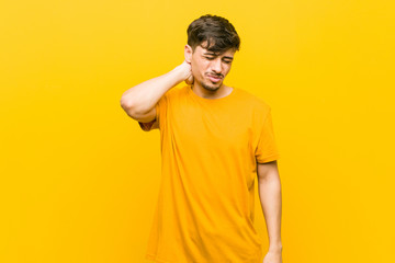 Young hispanic casual man suffering neck pain due to sedentary lifestyle.