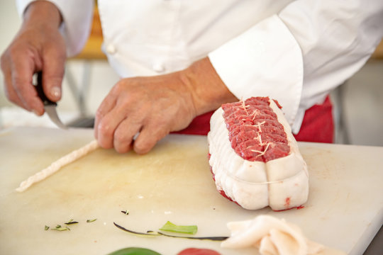 butcher preparing a rosbeef on his work plan