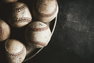 Dark rugged baseball background with copy space by balls.