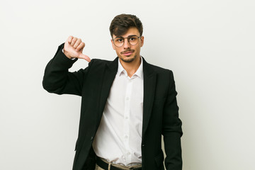 Young business hispanic man showing a dislike gesture, thumbs down. Disagreement concept.