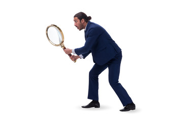 Businessman with giant magnifying glass