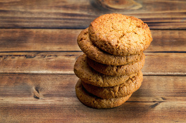 Stack of oatmeal cookies on wooden surface