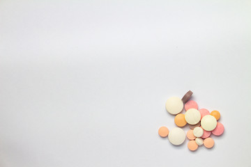 Colored pills on white background. Concept of medication abuse.