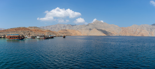 Panorama View from Dhow Boat to spectacular rocky mountains of northern Oman in Musandam in the fjords.