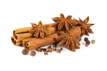 Cinnamon, star anise, cloves and mixture of peppers isolated on white
