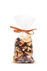 Dried fruits in transparent plastic bag on white background