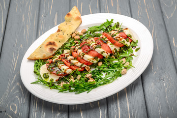 Italian trditional caprese salad with pesto sauce and basil