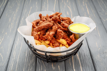 Fried crispy chicken nuggets with french fries and ketchup