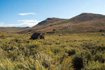 hillside landscape with abandoned old west buildings ghost town