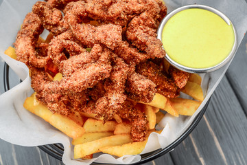 Fried crispy chicken nuggets with french fries and ketchup