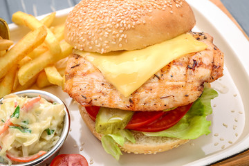 Tasty and appetizing hamburger cheeseburger. On a wooden table