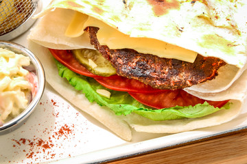 Pita with roasted chicken and vegetables, served with a delicious sauce