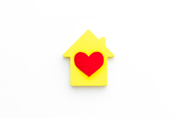 Happy life and home concept. House cutout and heart icon on white background top view copy space