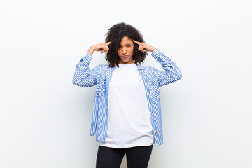 young cool african american woman with a serious and concentrated look, brainstorming and thinking...