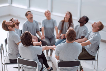 group of concentrated people sitting in a circle.