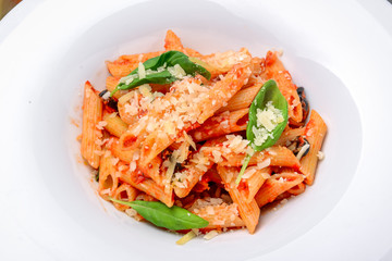 Penne pasta with shrimp and mussels, tomato sauce, basil and grated parmesan cheese