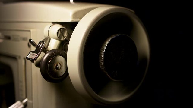 An old Sears or Kenmore sewing machine, single wheel moving.