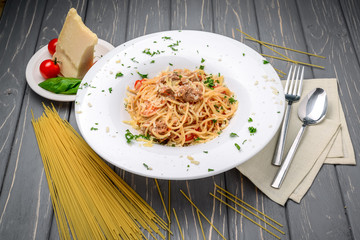 spaghetti dinner with meat sauce and basil close up