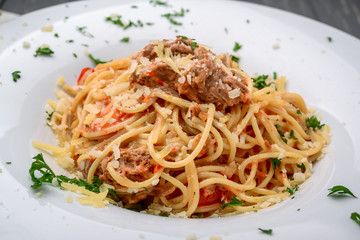 spaghetti dinner with meat sauce and basil close up