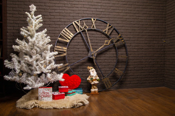 white christmas tree on brick wall and clock background