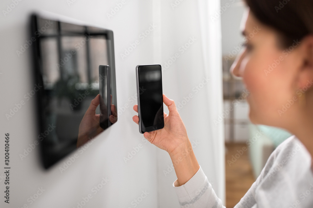 Poster automation, internet of things and technology concept - woman using tablet pc computer and smartphon
