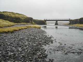 Bridge crossing in fjadrargljufur canyon in Iceland with moody weather