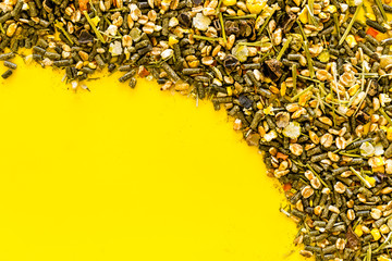 Pet food for rodents like rabbits, guinea pigs, hamsters on yellow background top view copy space frame