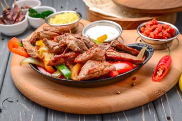 Fried meat with different vegetables with sauce