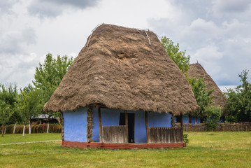 Fototapeta na wymiar Traditional blue cottage made of wood, straw and clay in Oas County heritage park in Negresti-Oas, Romania