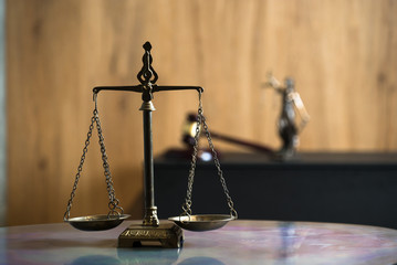 Law and Justice concept. Mallet of the judge, books, scales of justice. Gray stone background,...
