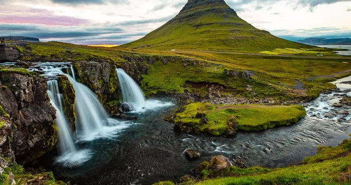 Iceland time lapse video of waterfall and famous mountain. Kirkjufellsfoss and Kirkjufell in northern Iceland nature landscape. Timelapse photography in 4K. 8K UHD available