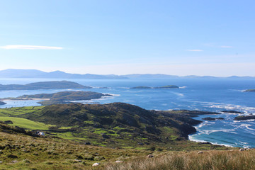 view of the coast from the mountains. green slopes of the mountains in the foreground