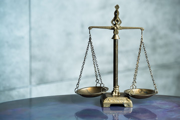 Law and Justice concept. Mallet of the judge, books, scales of justice. Gray stone background,...