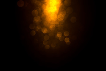 Golden abstract bokeh on black background. Holiday concept.