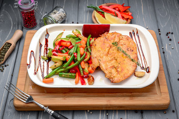 Grilled steaks, baked potatoes and vegetables