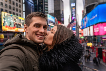 young couple self portrait in times square