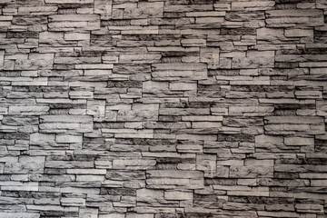 Gray brick wall overlapping into layers.