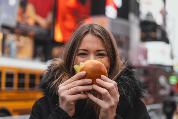 woman has fun with junk food in the city of new york