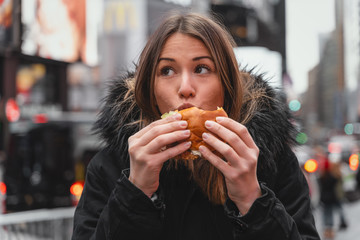 woman has fun with junk food in the city of new york