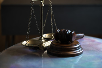 Law and Justice concept. Mallet of the judge, books, scales of justice. Gray stone background,...