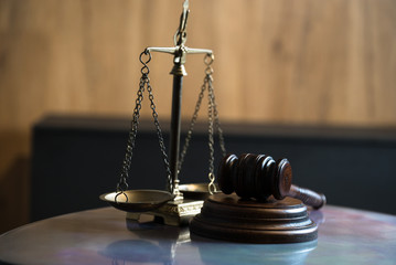 Law and Justice concept. Mallet of the judge, books, scales of justice. Gray stone background,...