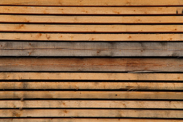 Fototapeta premium Abstract wood background. Unpainted natural wood surface from horizontal planks. Close-up, cropped shot, horizontal, free space, top view. Design and construction concept.