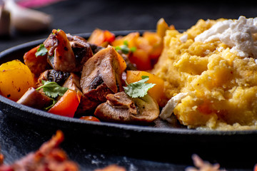 Traditional Romanian mamaliga, corn mush, along with vegan meat, sauerkraut, mixed vegetables
