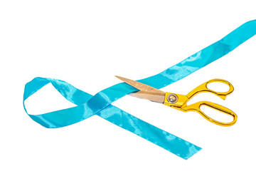 Scissors with golden handles cuts a blue ribbon on a white background, for working with fabric.