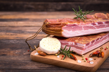Homemade smoked bacon on wooden board