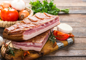 Homemade smoked bacon on wooden board