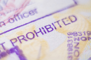 Kyiv, Ukraine - November 2019: close up of customs stamp with the word Prohibited in focus