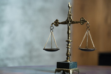 Law and Justice concept. Mallet of the judge, books, scales of justice. Gray stone background,...